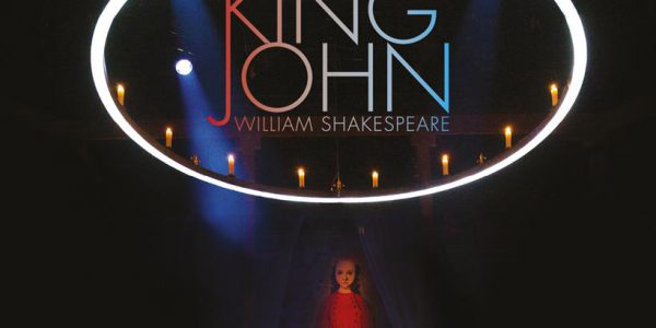Poster for King John, featuring a woman sitting below a large circle illuminated with candles.