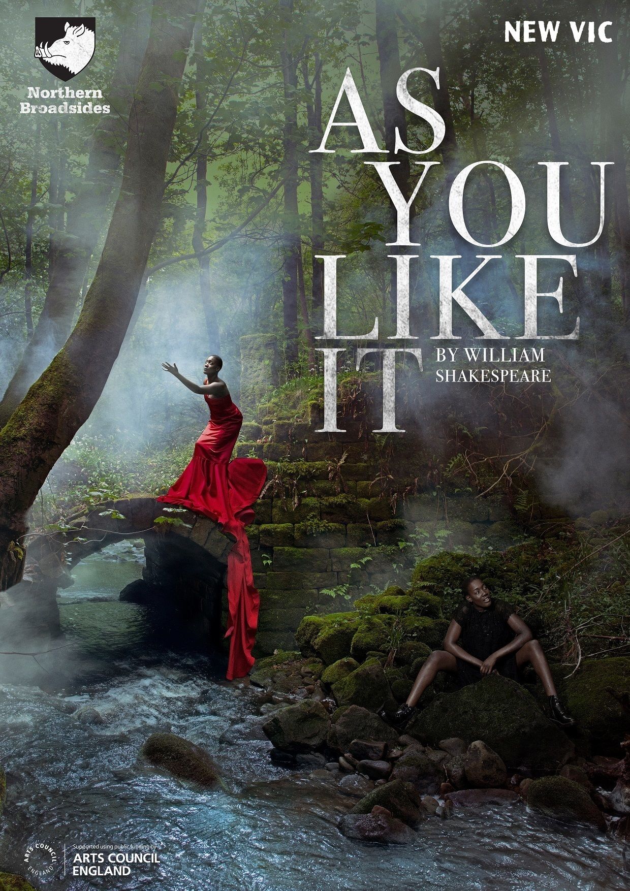 Poster for As You Like It, featuring a Black woman in a red dress gesturing and a Black woman in black clothes sitting in a forest next to a ruined bridge.