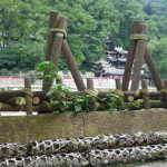 A photograph of bamboo gabions and wooden tripods along the Min River