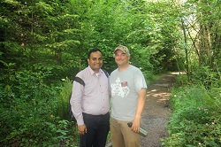 A photograph of Ahilan at Crystal Springs (a tributary of  Johnson Creek) with Zac Perry, riparian restoration specialist