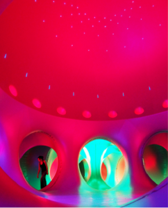 Inside a Luminarium, blue and red columns and chambers.