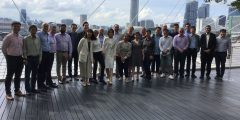 Attendees of Singapore UK Jet Zero Workshops standing on decking with buildings in the background