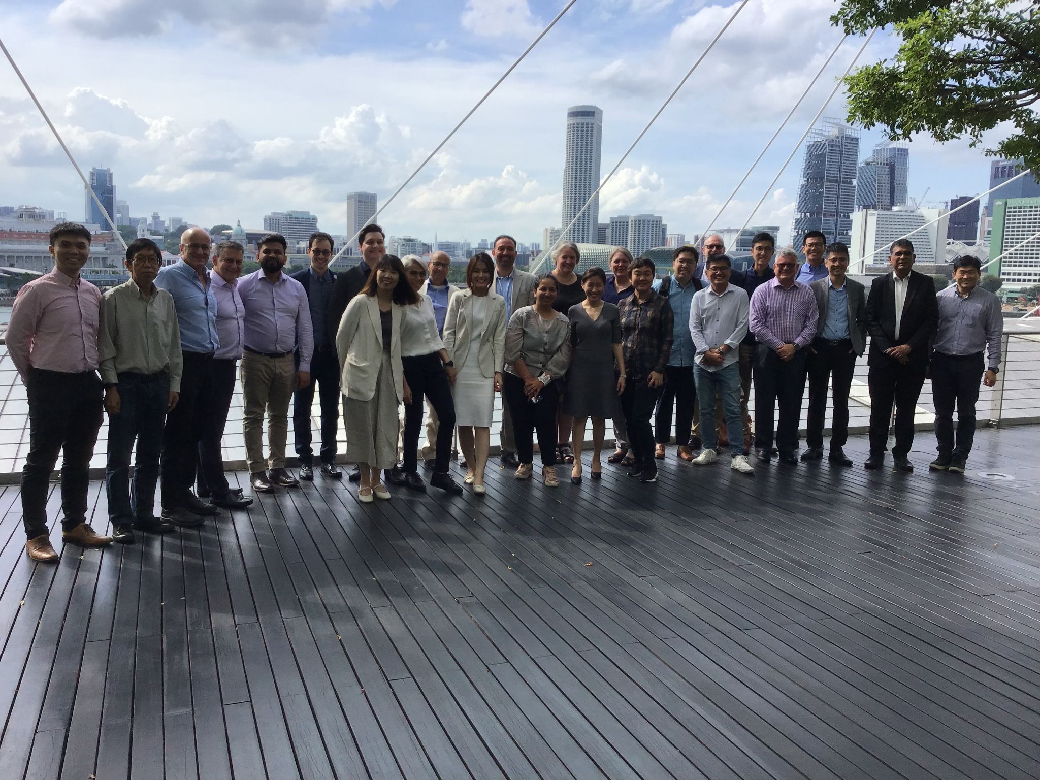 Attendees of Singapore UK Jet Zero Workshops standing on decking with buildings in the background