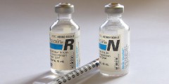 Two vials of insulin and a syringe
