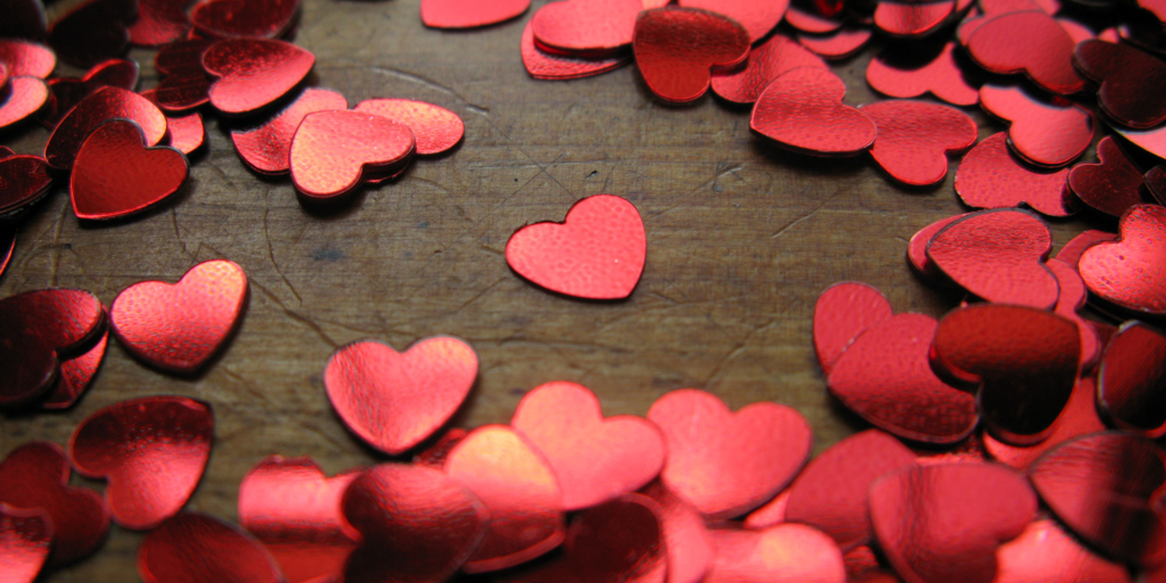 A collection of heart confetti scattered on a table to symbolize valentines day
