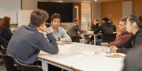 Students interacting with alim, alumnus about how sport has impacted his experience