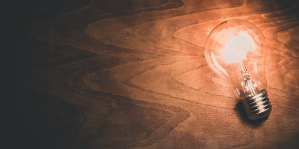 Light Bulb on Wooden Background