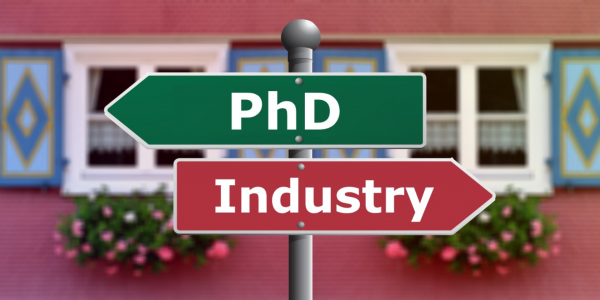 A signpost with the word PhD pointing left and another signpost with the word industry posting right