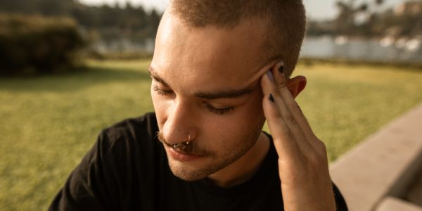 Man touching his temple showing anxiety