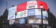 Digital billboards in London showing popular brands such as Coca Cola and TDK.
