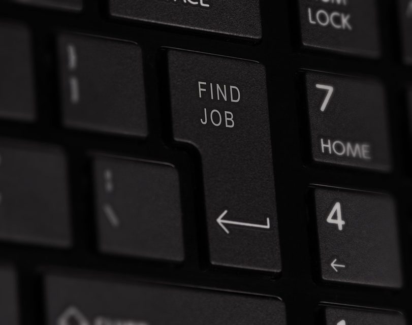Part of a black computer keyboard. Shows the entre key but it says 'Find Job' instead of enter.