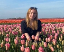 Charlie Herring sitting in a field of tulips
