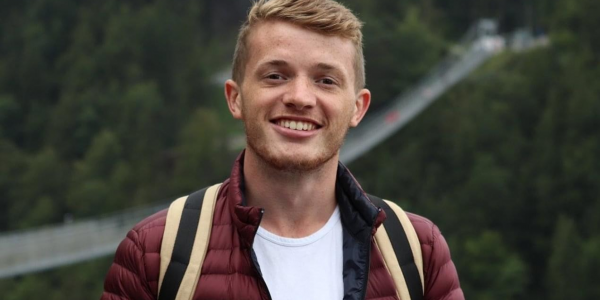 A picture of Adam, a blonde male who is smiling.