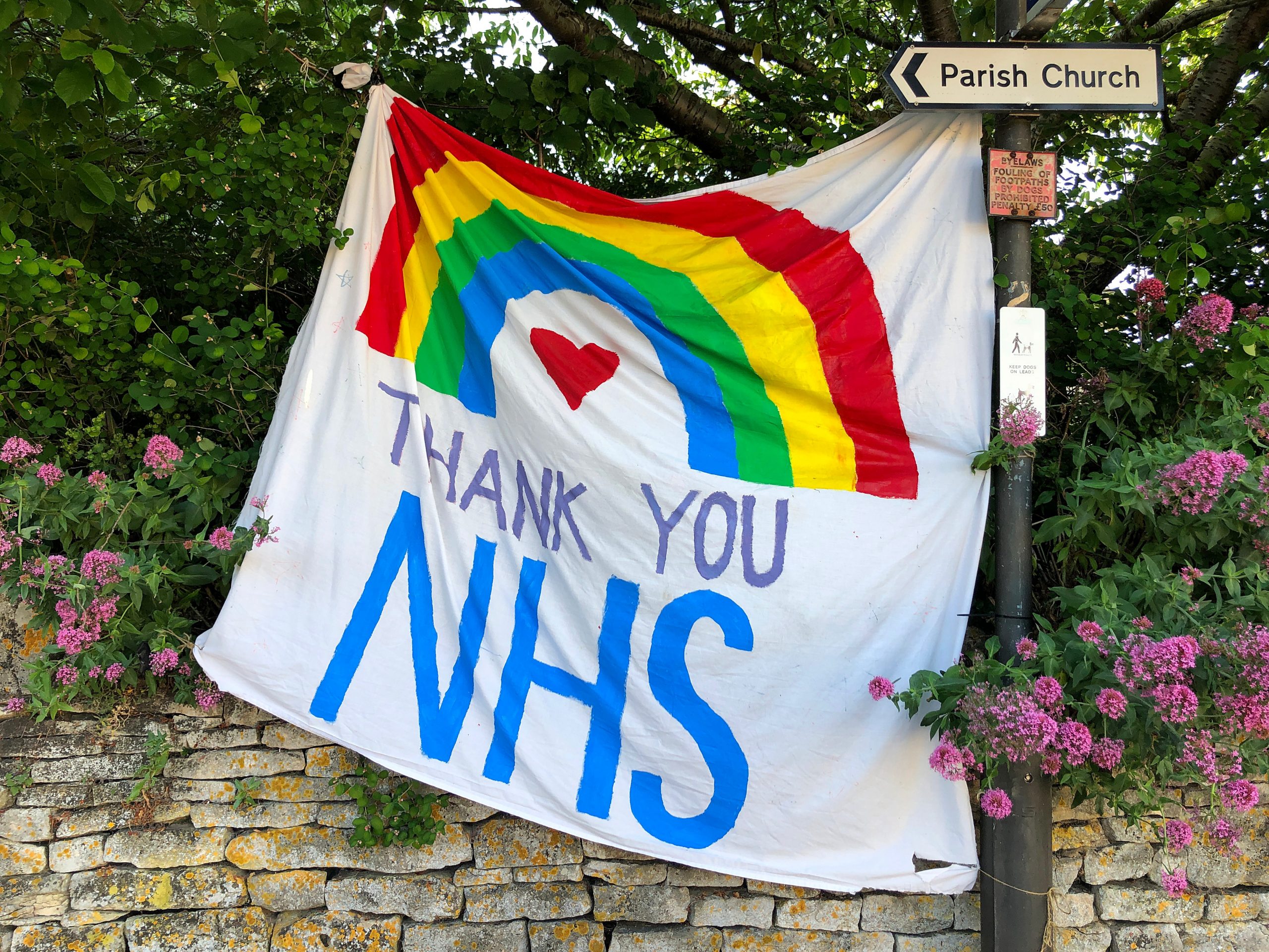 A piece of artwork that says 'Thank you NHS' with a rainbow over it.