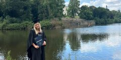 Isobel Evans on graduation day by the lake