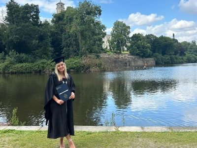 Isobel Evans on graduation day by the lake