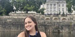 Claudia Medina Munoz in a boat on the lake with the Trent Building in the background