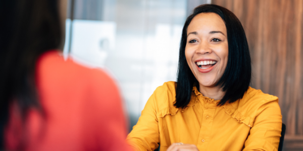 Woman smiling at a colleague in an office setting