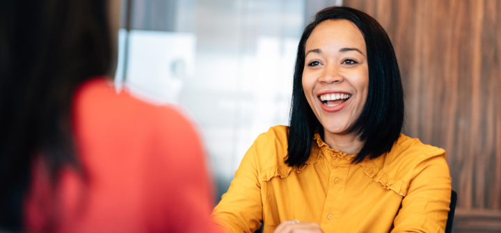 Woman smiling at a colleague in an office setting