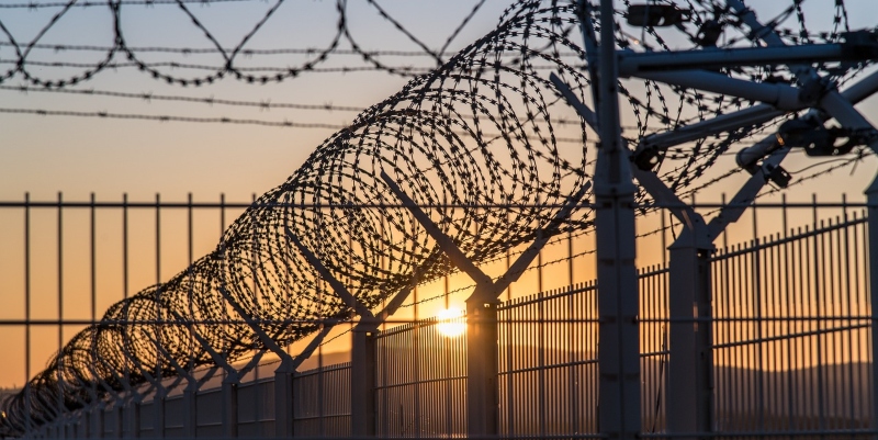 Prison barbed wire at sunset