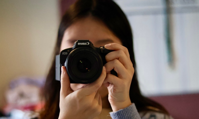 Picture of Hongwei Lang taking a picture of herself with a camera