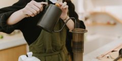 A close up of a barista pouring coffee