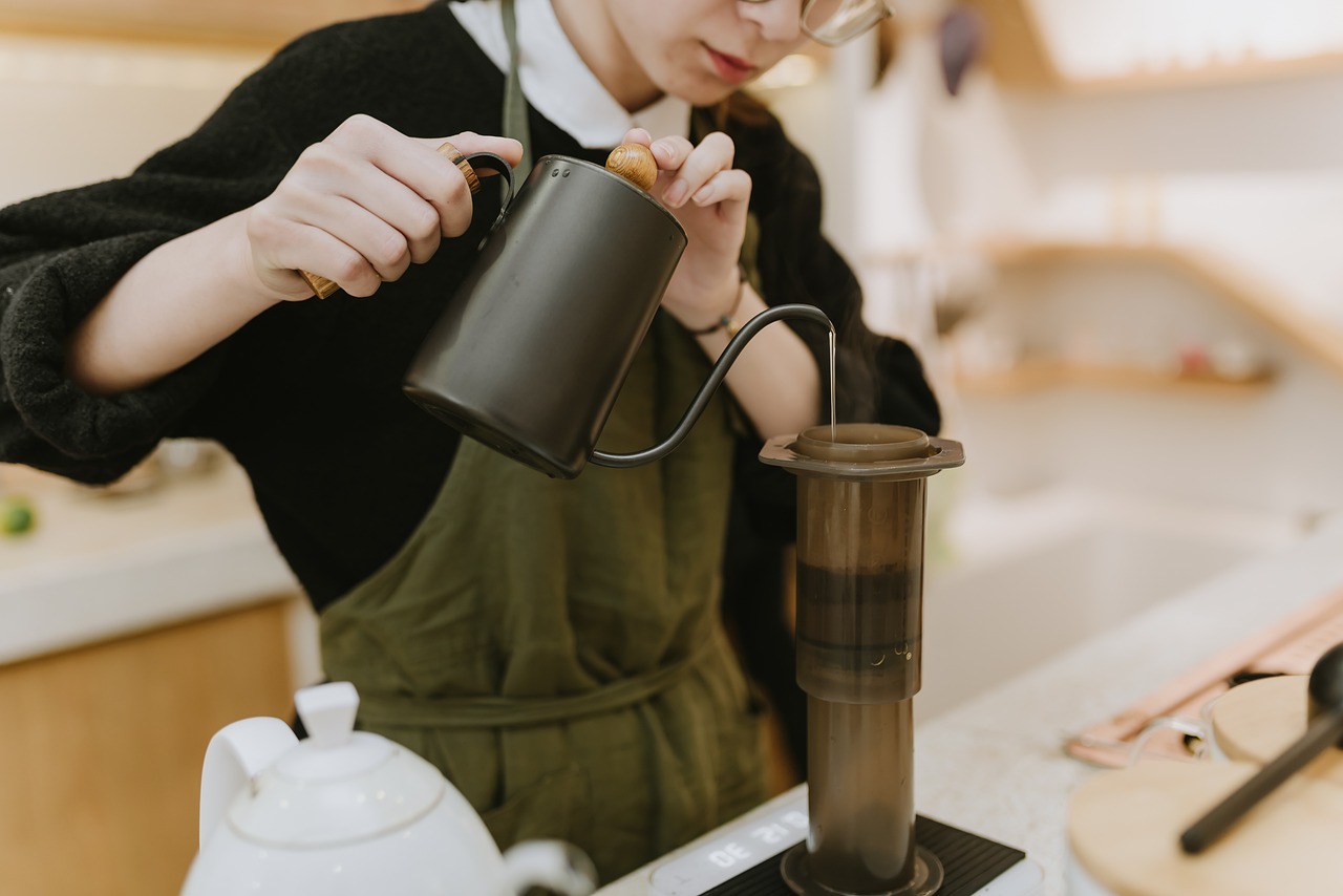 A close up of a barista pouring coffee