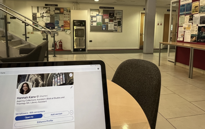 Laptop on a table showing a student LinkedIn profile