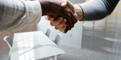 A close up of two people shaking hands