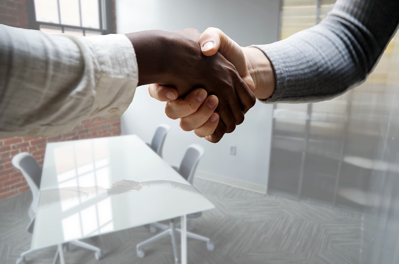 A close up of two people shaking hands