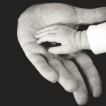 Picture of a child and an adults hand