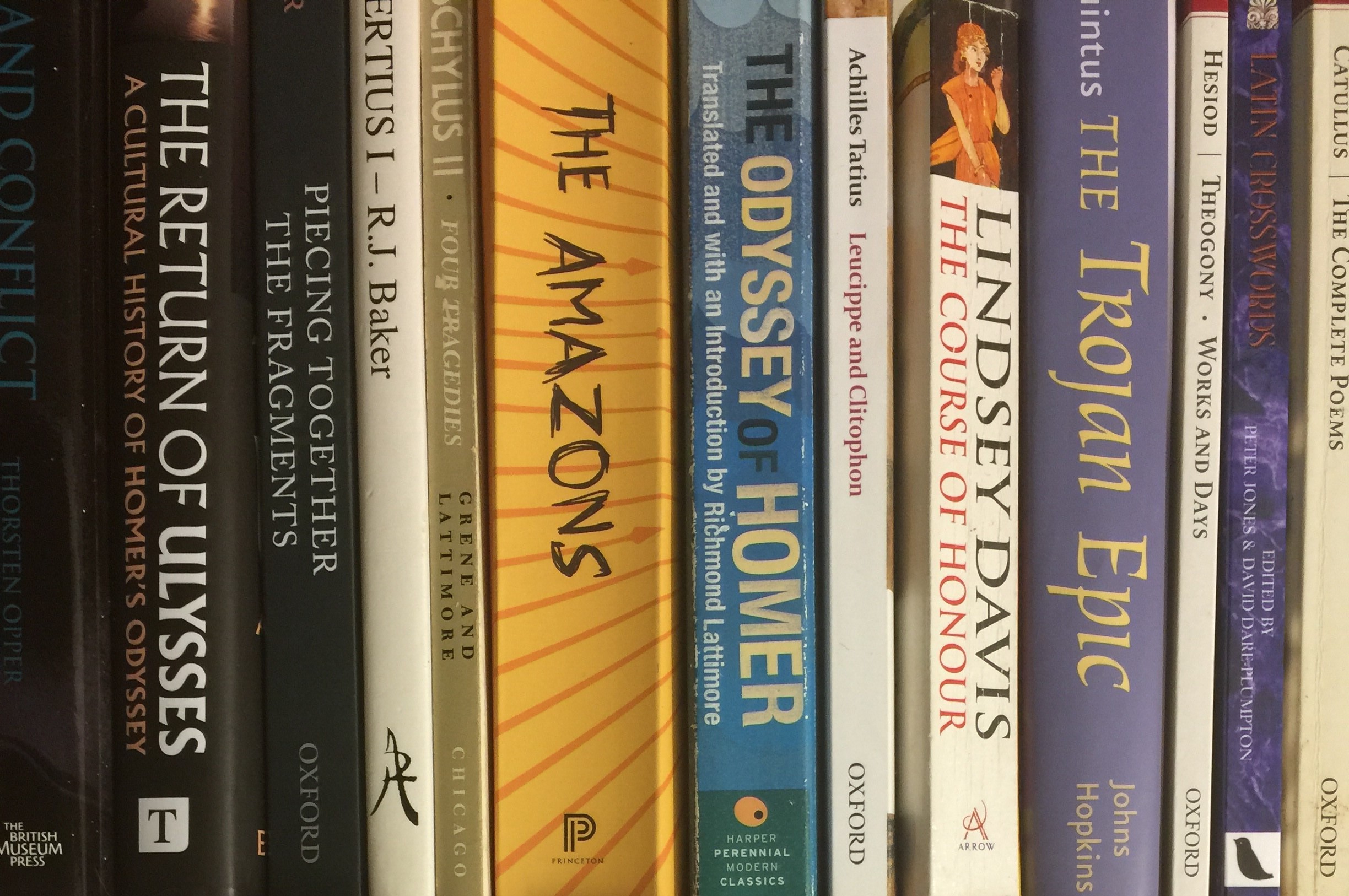 a photograph of classics books on a shelf, spines facing outwards.