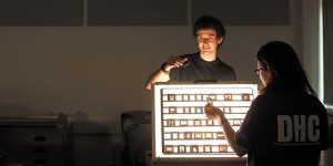 DHC volunteers examine slides using light-boxes.