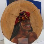 Adagio Nkwocha’s self-portraits; each on one side of the same section of wood