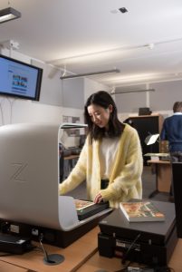 Photo of a student using the bookscanner