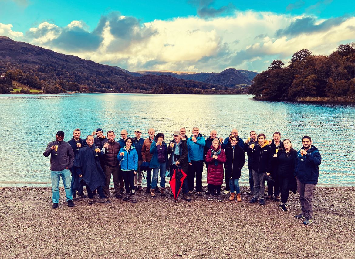Future Food Director Andy Salter with other attendees of the Rank Prize meeting, standing in front of a lake with clouds in the background
