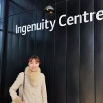 Serena smiles for a photograph in front of the Ingenuity Centre building sign