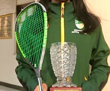 Faiza Zafar and a winner's trophy in squash