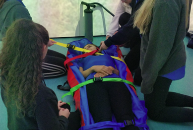 student lying on a stretcher in the immersive suite