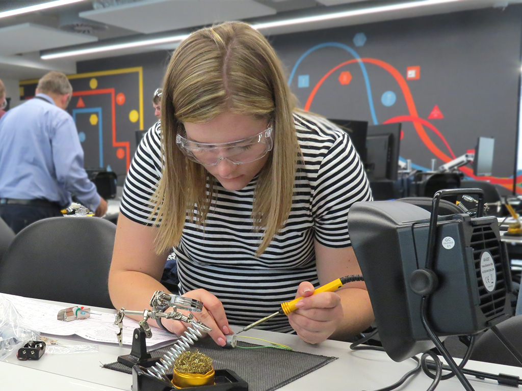An apprentice on the electro-mechanical engineer programme in the teaching laboratory