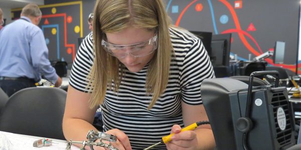 An apprentice on the electro-mechanical engineer programme in the teaching laboratory