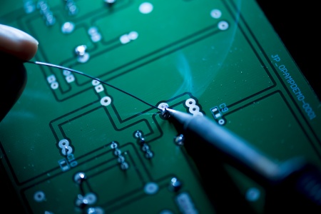 Electronic Support Technician working on a soldering board in the Electronic Support Workshop, Engineering, University Park