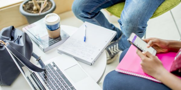 Top down image of students studying and working on laptops