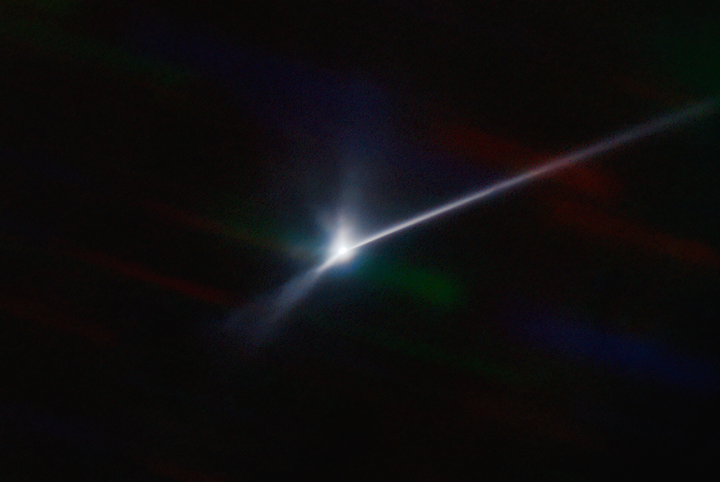 Aftermath of DART collision with Dimorphos, captured by SOAR telescope. Tail visible as long white streak against black space.