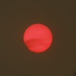 Red sun as seen through smoke after wildfire
