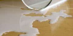 Photo of milk spilt out of glass onto a table