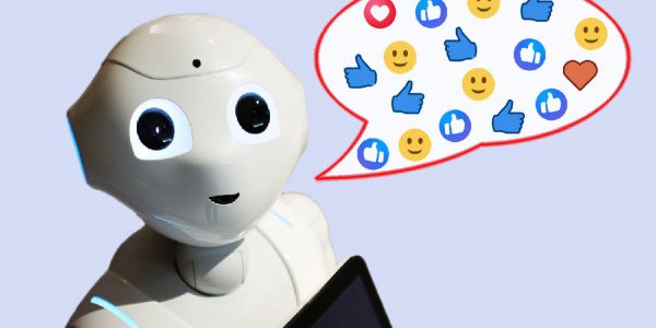 a robot with googly eyes and a speech bubble full of emojis