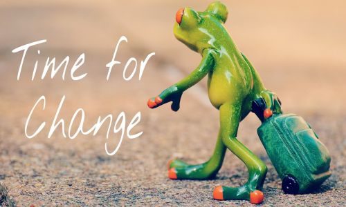 fog carrying suitcase through desert with Time for Change written in white