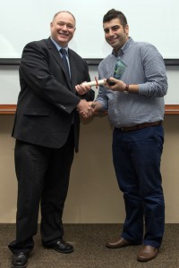 Figure 4 Professor Graham Kendall presenting Reza with the 3MT® People's Choice award