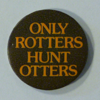 Round black badge with gold text 'Only Rotters Hunt Otters' 